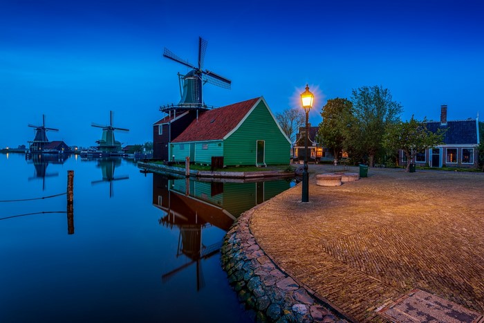 Windmills and houses at Zaanse Schans, Netherlands in the evening
