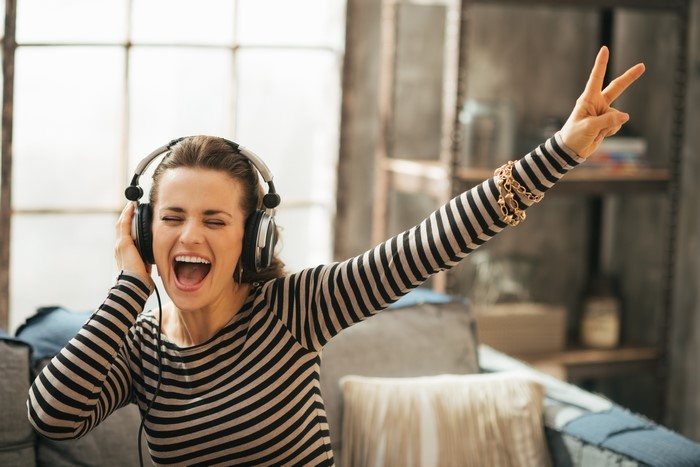 Woman wearing headphones and singing