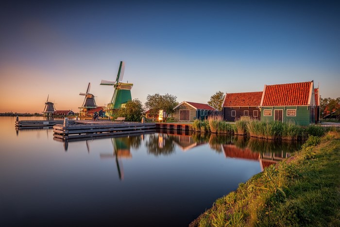 Windmills and houses at Zaanse Schans, Netherlands at sunset