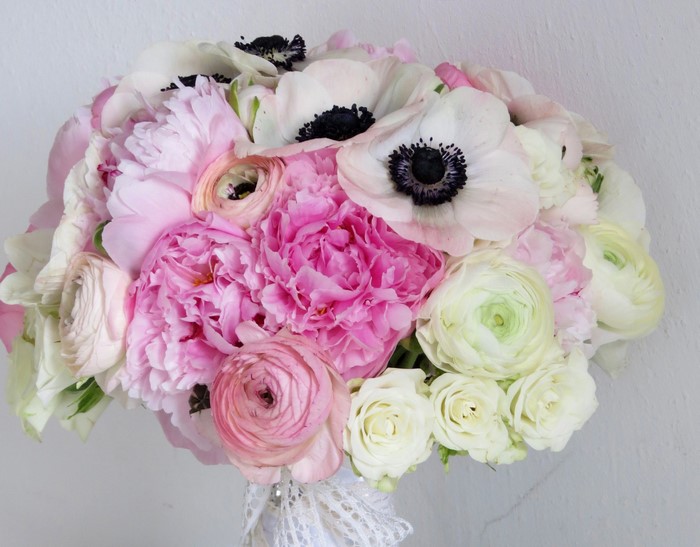 Pink and white floral bouquet with peonies, roses, ranunculus, and anemones