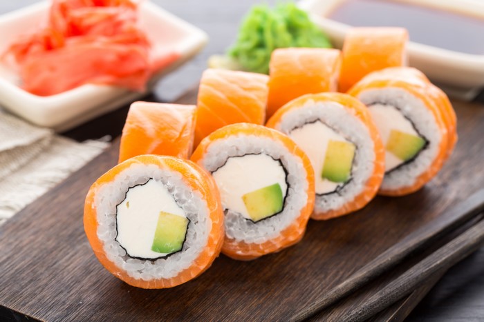 Salmon and avocado sushi rolls with ginger and wasabi