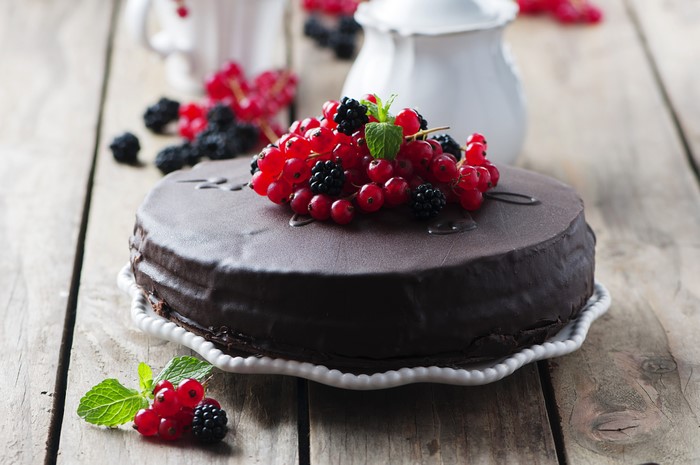 Chocolate cake with red currants and blackberries