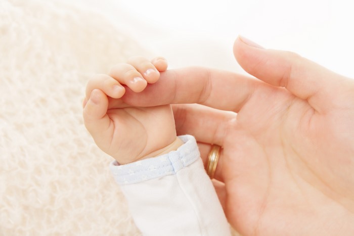 Baby's Hand Holding Adult Finger