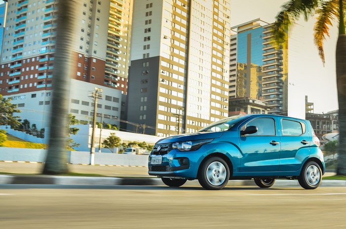 Blue Fiat Mobi Easy driving on a city street