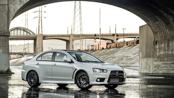 White 2015 Mitsubishi Lancer Evolution X under bridge
