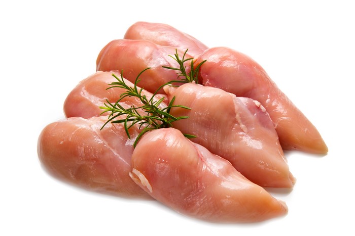 Raw chicken breasts with rosemary sprigs