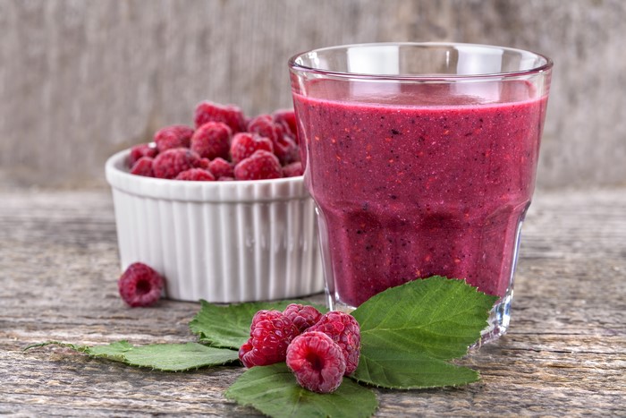 Raspberry Smoothie in a Highball Glass with Fresh Raspberries