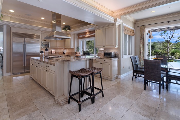 Kitchen with island, refrigerator, and dining table