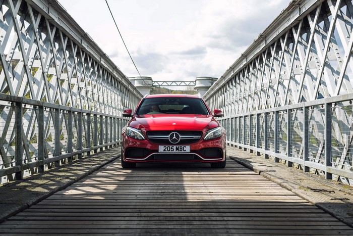 Red 2015 Mercedes-Benz AMG C 63 Estate on a bridge