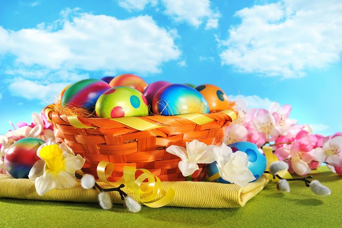 Easter eggs in a wicker basket with flowers
