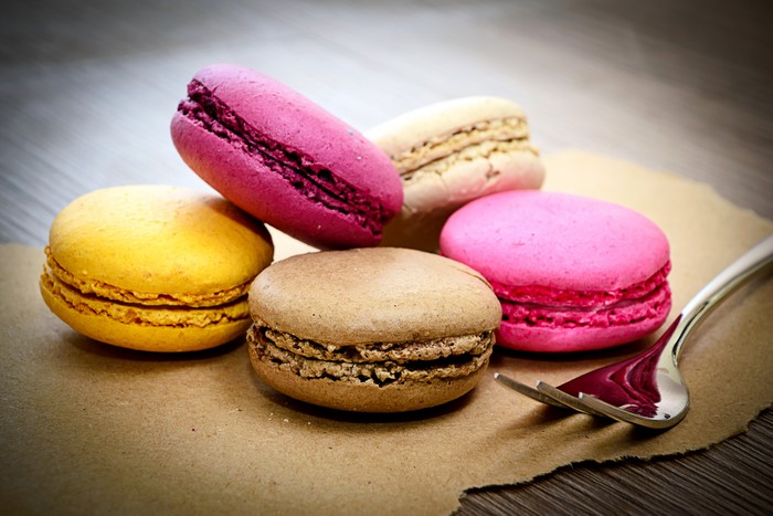 Assortment of colorful macarons with a fork