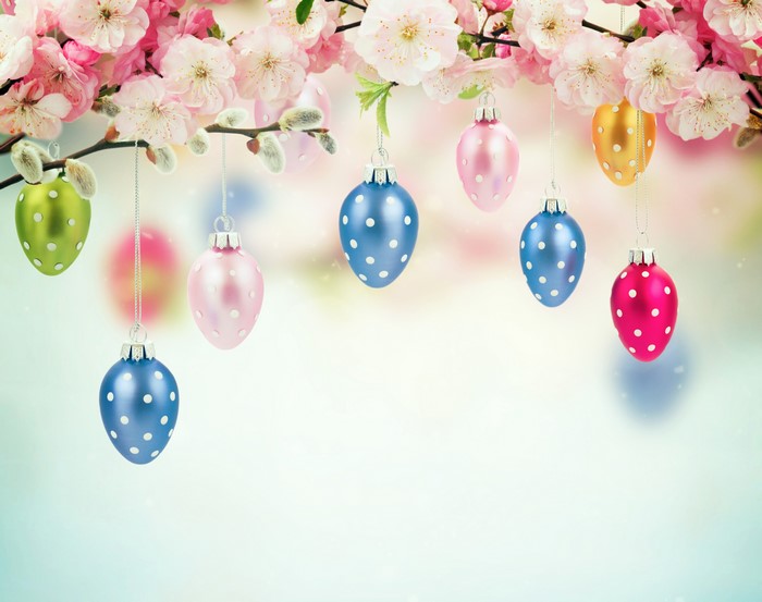 Easter eggs hanging on flowering tree branches