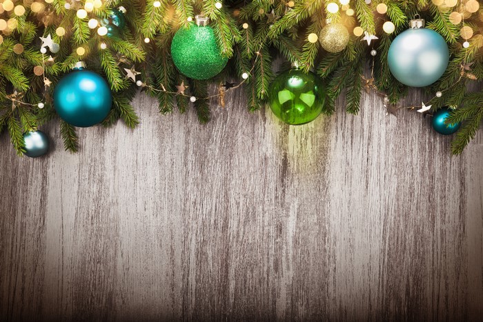 Christmas balls and fir branches on wooden background