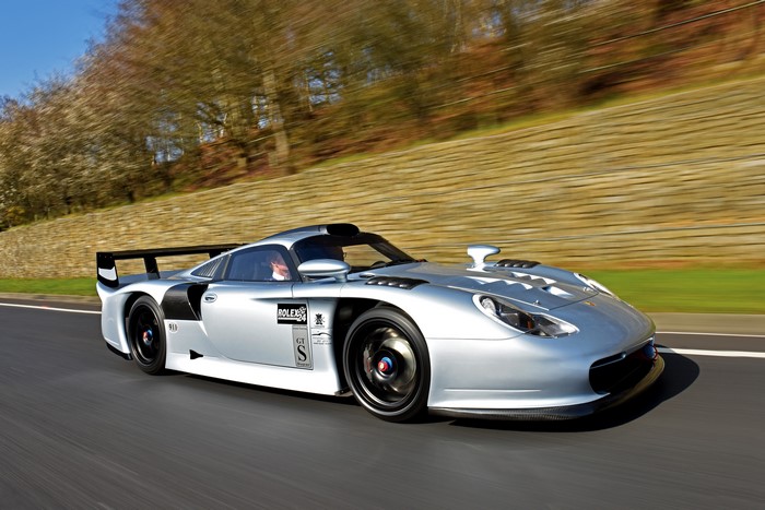 Silver Porsche GT2 RS race car on a road