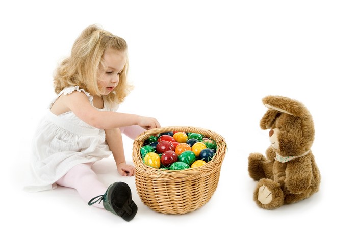Girl with Easter eggs and teddy bear