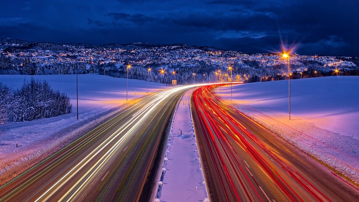 Light trails on a snowy highway at night in Trondheim, Norway