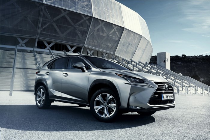 Silver Lexus NX 2014 EU-spec parked outside modern building