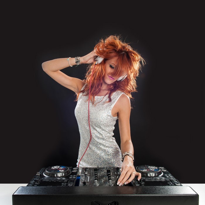 Redhead DJ girl with headphones