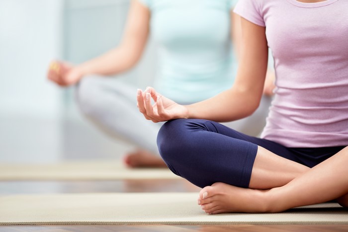 Two women meditating in Lotus position