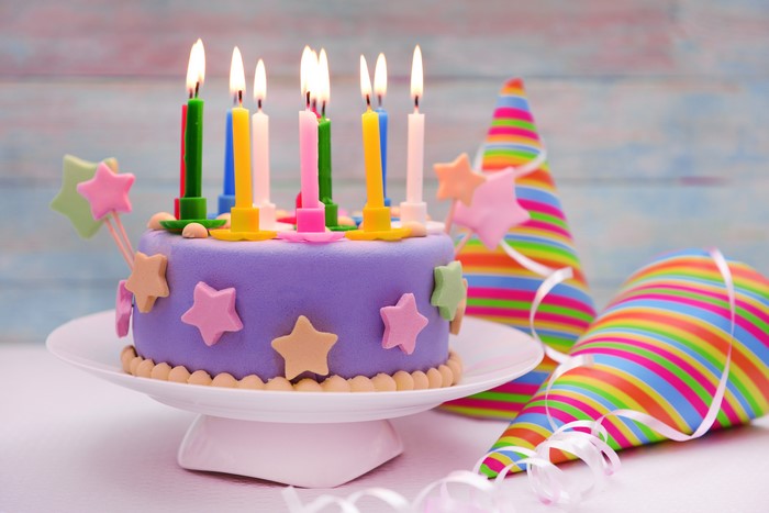 Birthday cake with candles and party hats