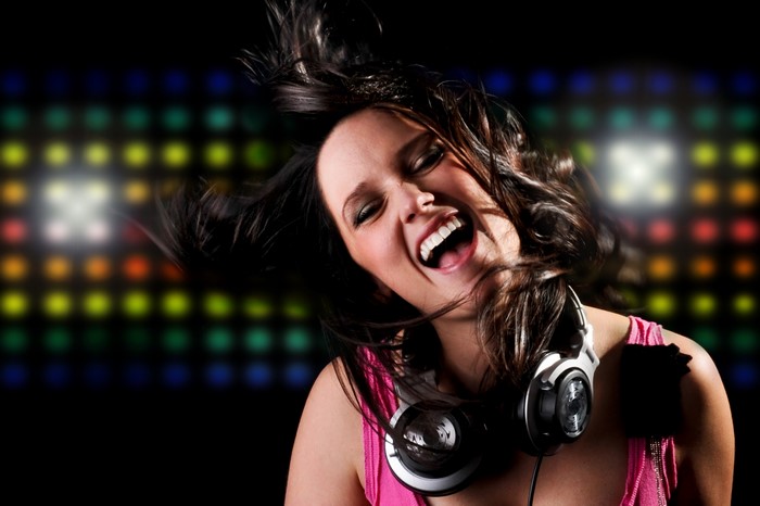Brunette girl with headphones laughing
