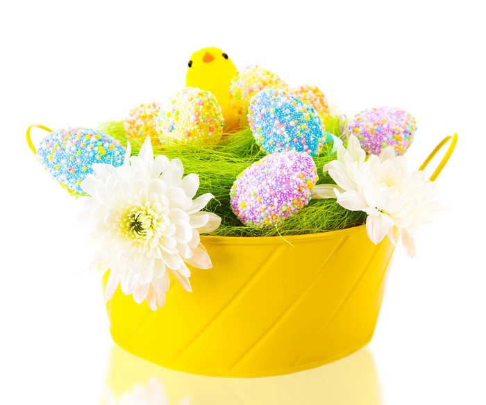 Easter basket with decorated eggs and a chick
