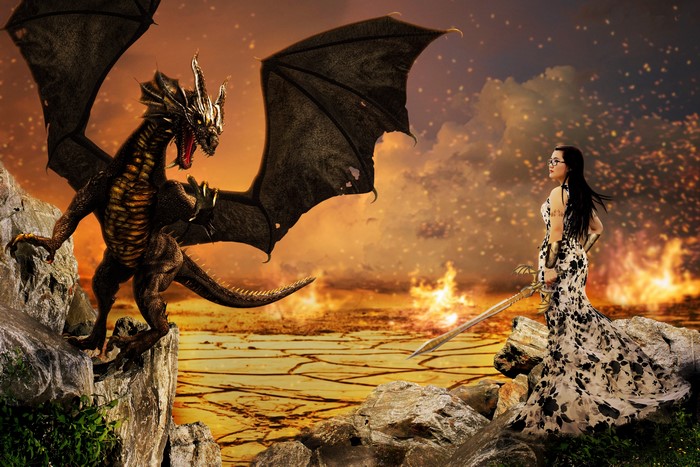 Dragon and woman with sword in fiery landscape