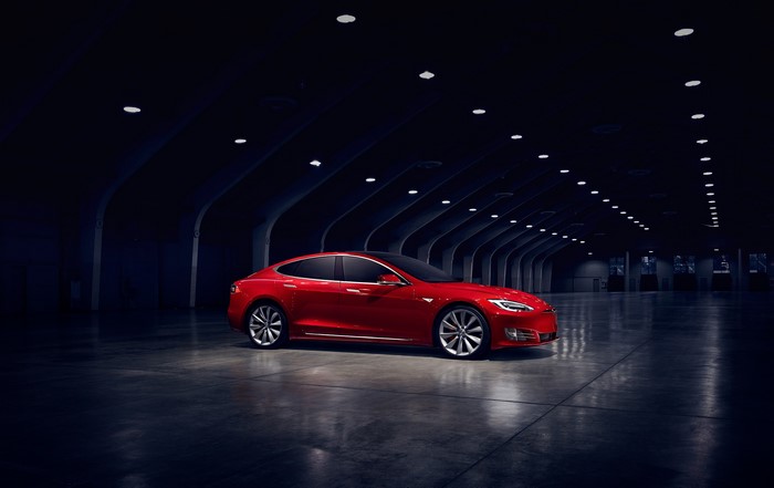 Red Tesla Model S in a dark hall