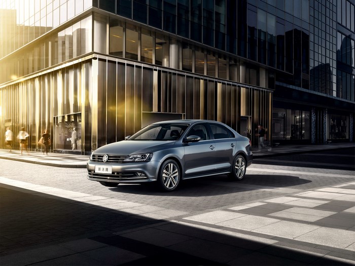 Volkswagen Sagitar parked in front of a modern building