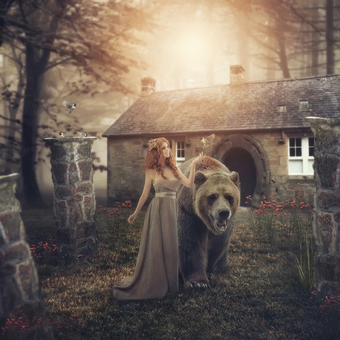 Woman with a bear and birds near a stone house