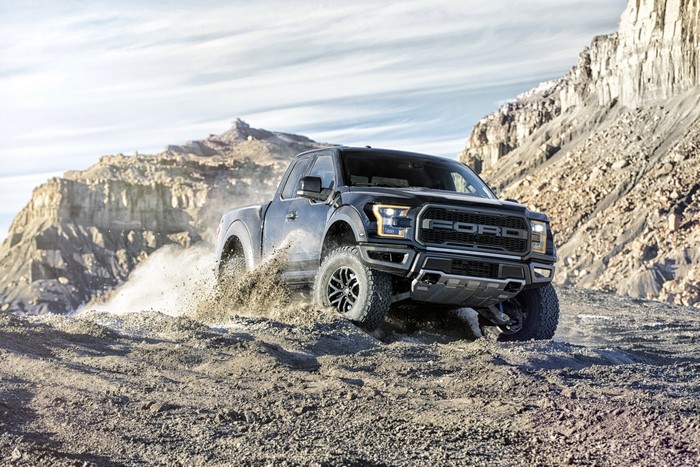 Black Ford F-150 Raptor driving off-road