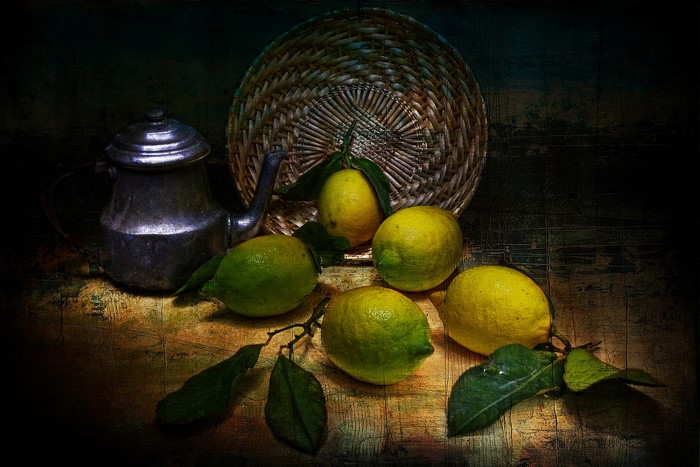 Still life with lemons and a metal teapot
