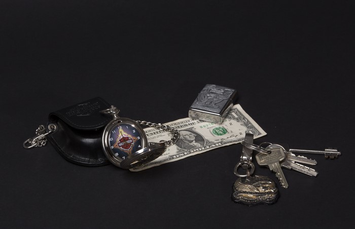 Harley-Davidson pocket watch, dollar bill, lighter, and keys