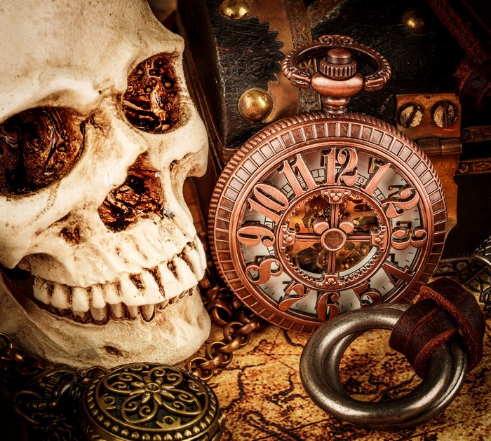 Skull and pocket watch on a map