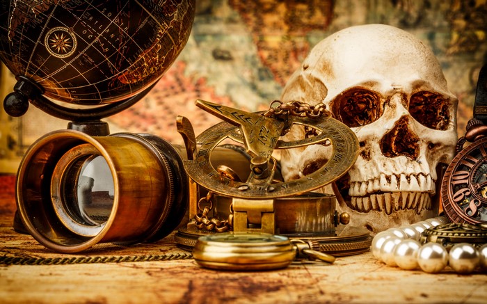 Skull, Globe, and Navigation Tools on Old Map