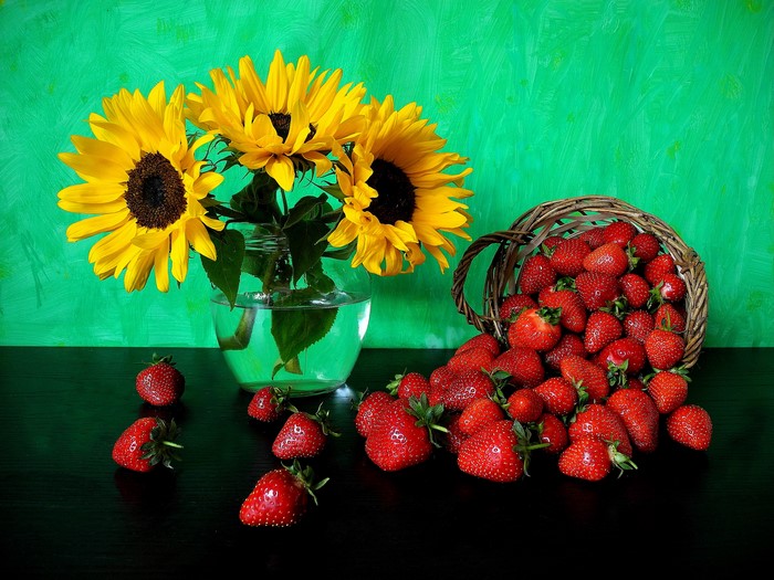 Sunflowers and strawberries in a still life