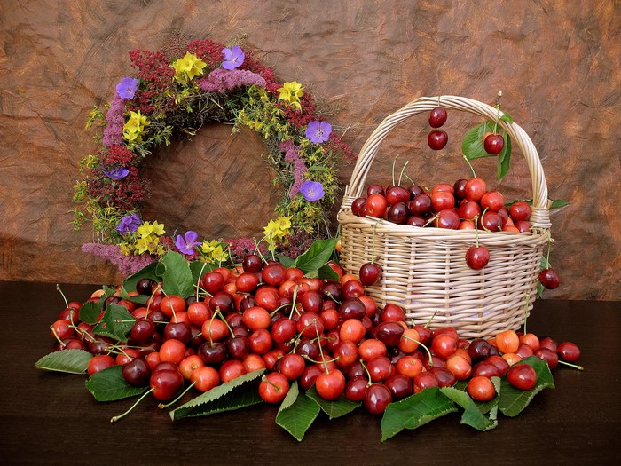 Still life with cherries and a floral wreath