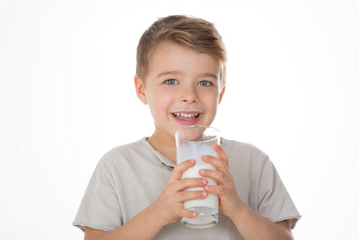 Boy holding a glass of milk