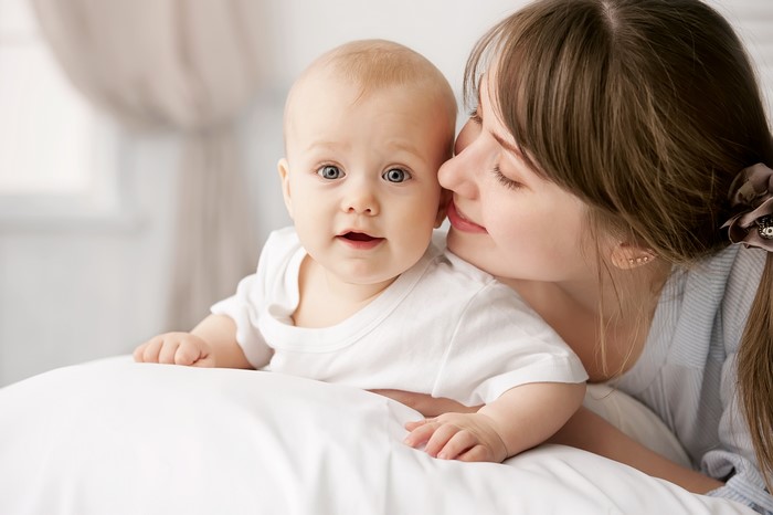 Mother kissing baby