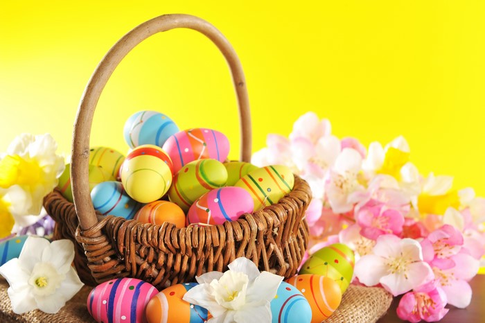 Easter Eggs in Wicker Basket with Flowers