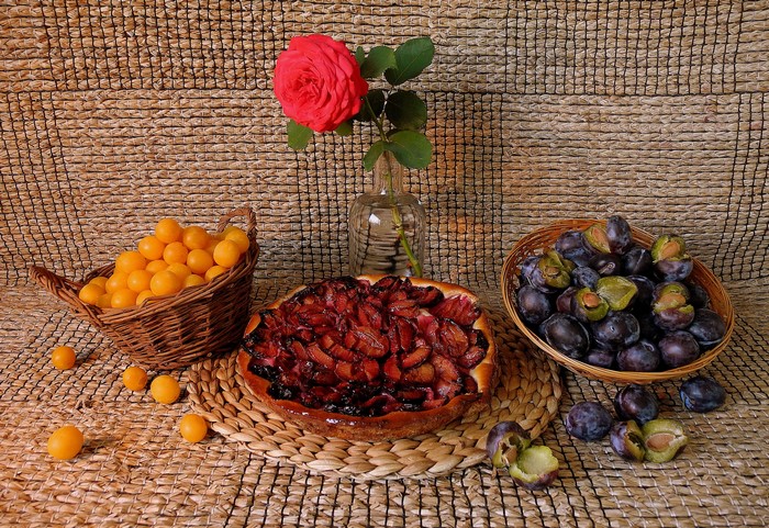 Still life with plums, rose, and pie