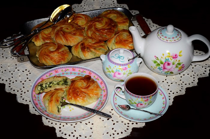 Pastries and tea set on a doily