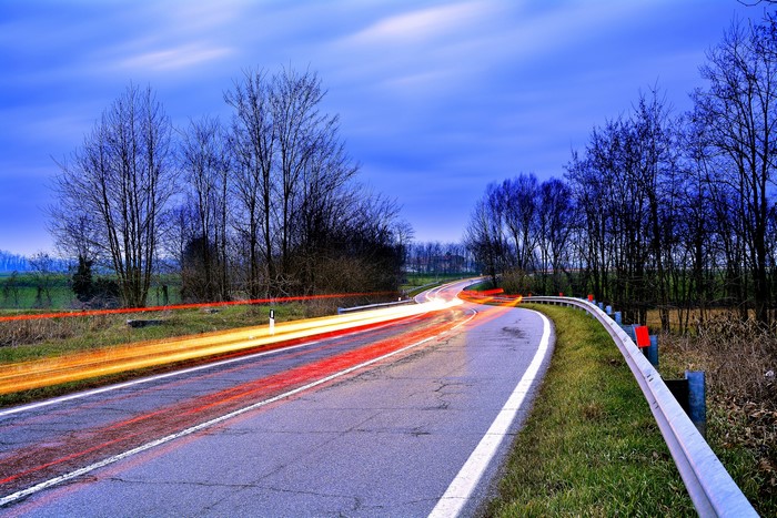 Road with light trails at dusk
