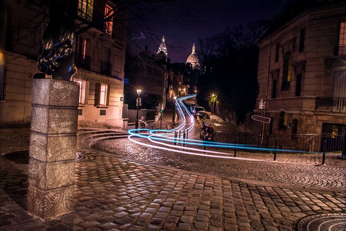 Paris street at night with light trails