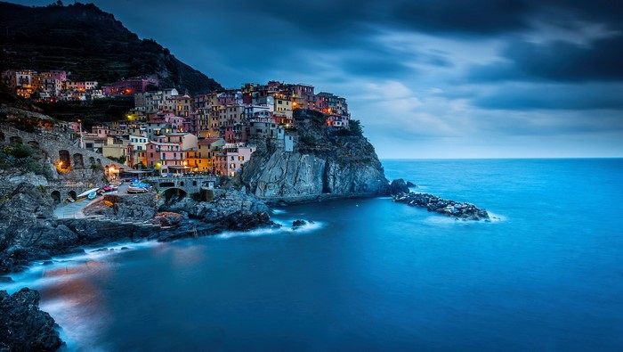 Manarola village on a cliff overlooking the sea in Italy