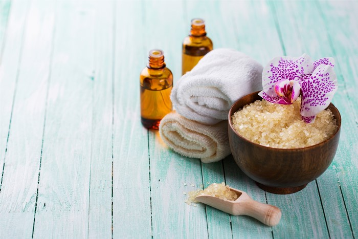 Spa essentials with orchid on wood planks