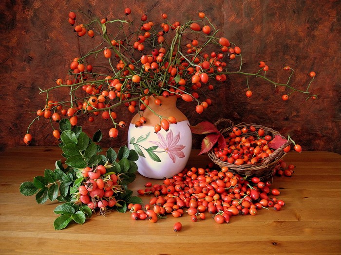Still-life with rose hips in a vase and basket