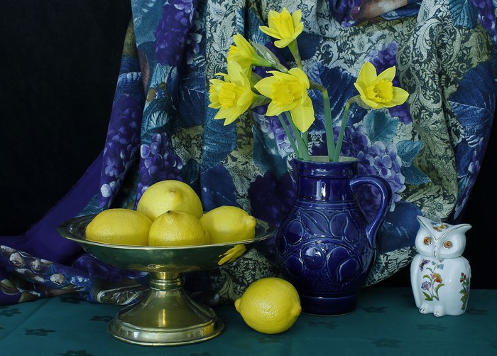 Still-life with daffodils, lemons, and owl figurine