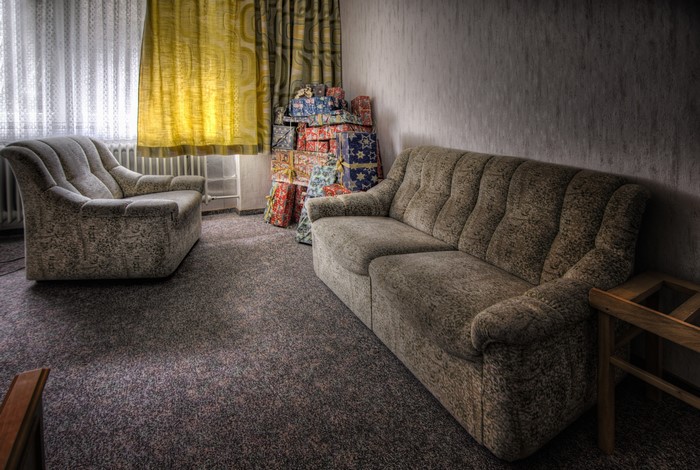 Sofa and armchair in a room with gifts