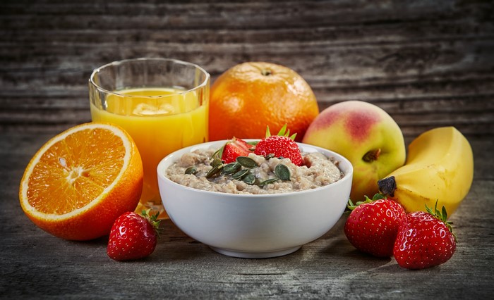 Still life of oatmeal with fruits and orange juice